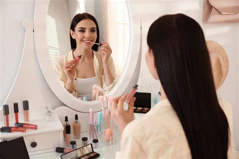 Beautiful Young Woman Applying Makeup Near Mirror Indoors Stock Image