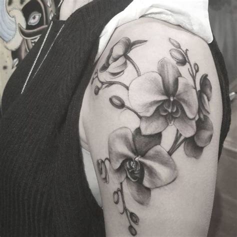 a woman with a black and white flower tattoo on her arm