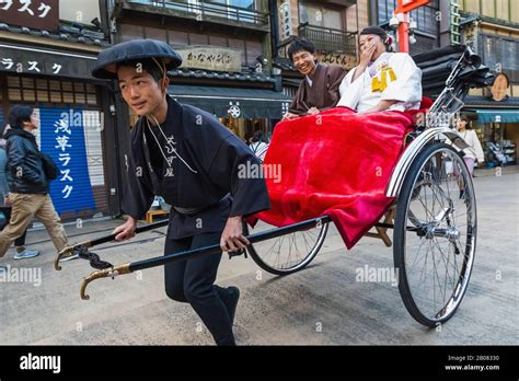 Japan Honshu Tokyo Asakusa Couple Riding In Rickshaw Stock Photo