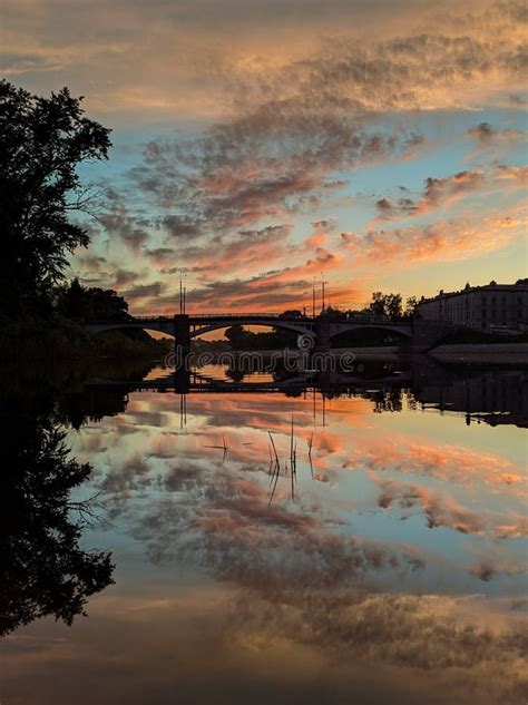 Sunset Sky Reflected In Water With A Centered Horizon Stock Photo