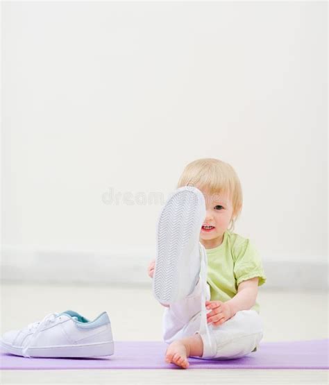 Baby Kicking In Camera With Big Sneakers Stock Photo - Image of room ...