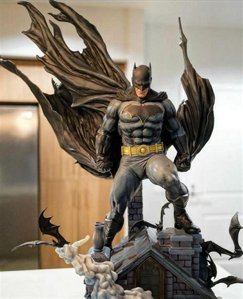 A Statue Of Batman On Top Of A Building