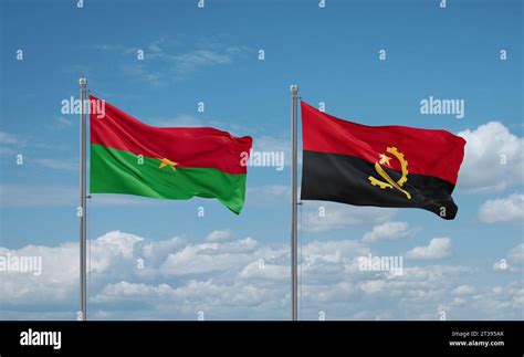 Burkina Faso And Angola Flags Waving Together In The Wind On Blue