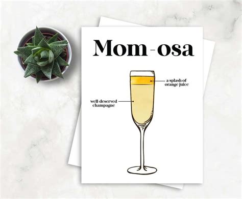 A Card With The Words Mom Osa And A Glass Of Champagne Next To It