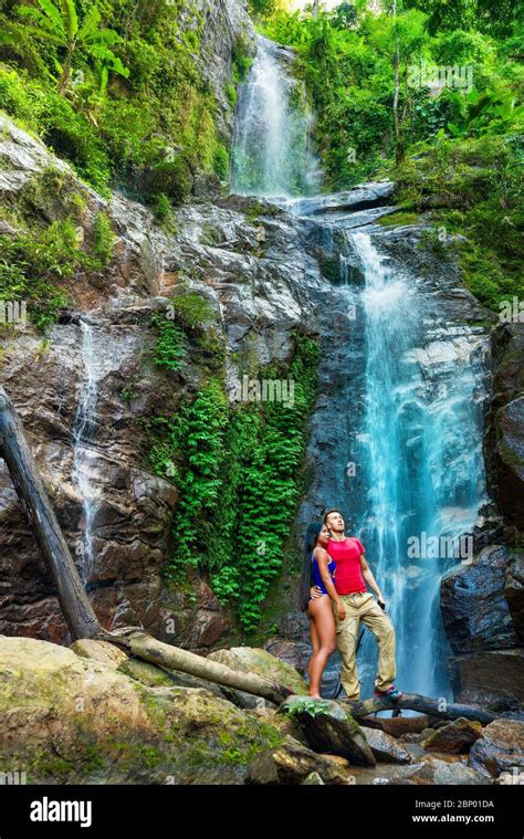 Couple Hugging And Kissing Under Waterfalls Stock Photo Alamy