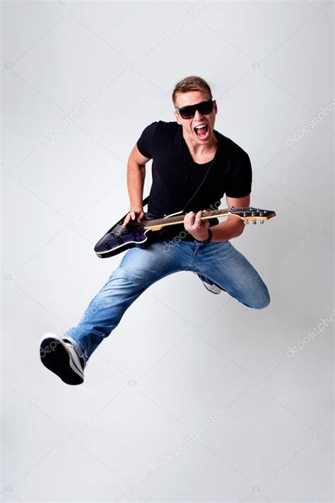 Rockstar leaping with guitar Stock Photo by ©baranq 11981588
