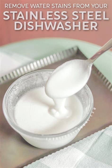 A Spoon Full Of White Liquid Sitting On Top Of A Metal Tray With The Words Remove Water Stains