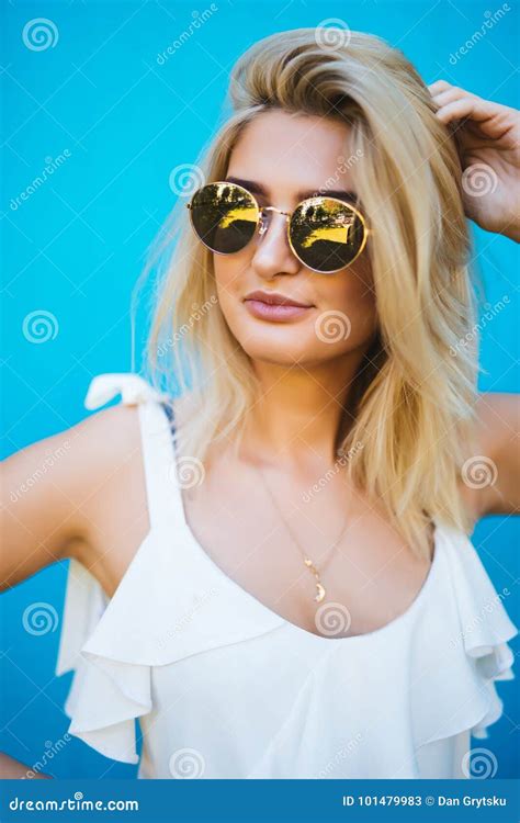 Close Up Shot Of Stylish Young Woman In Sunglasses Smiling Against Blue Background Stock Image