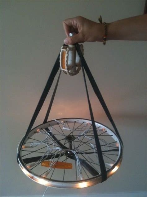 A Person Is Holding A Bicycle Wheel With Lights On Its Sides And