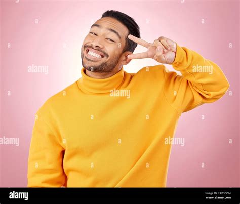 Happy, peace sign and portrait of man in studio for support, kindness ...