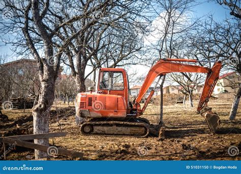 Backhoe Working By Digging Soil At Construction Site And Loading To The