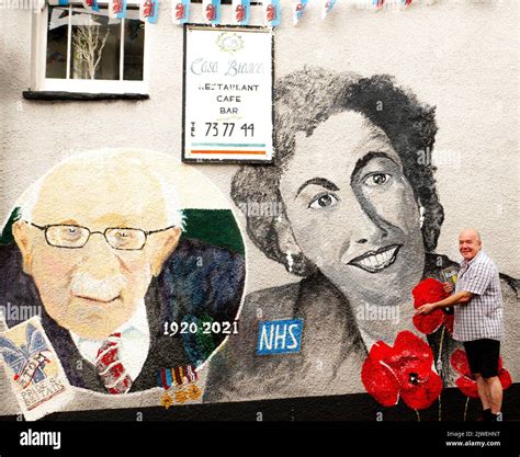 Paul Cable Newsagent And Local Abergavenny Artist Stands Beside A