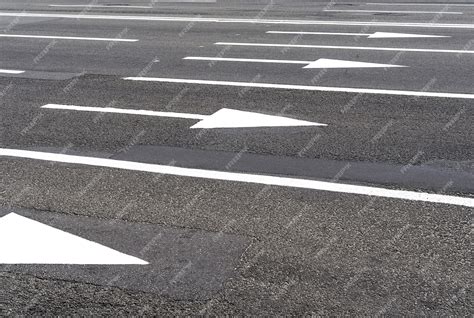 Premium Photo | White arrows road markings on asphalt roads and urban ...