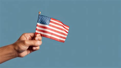 Premium Photo Hand Holding Mini United States Flag Holiday Concept