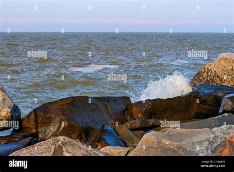 Wind Blown Waves Hit The Boulders Along The Wintery Shoreline Of Lake