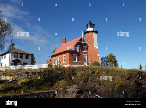 Eagle Harbor Lighthouse And Visitor Center Sit On Cliff Overlooking