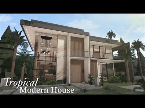 a tropical modern house with palm trees in the foreground and text ...