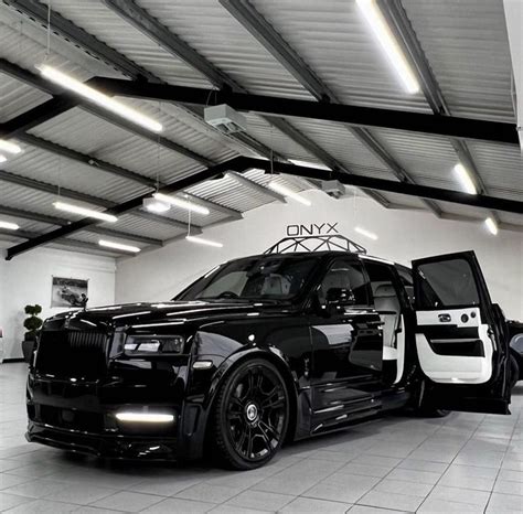 A Black And White Car Parked In A Garage