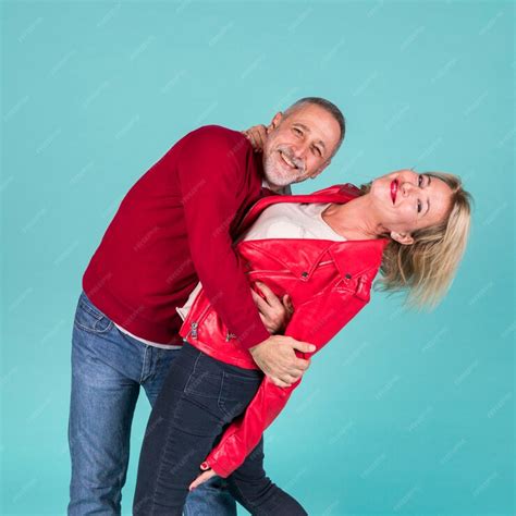 Free Photo Happy Romantic Mature Couple Standing Against Turquoise