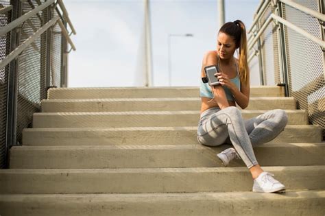 Premium Photo Young Female Runner Resting On The Stairs