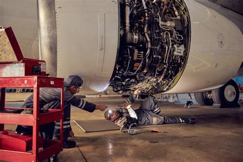 Aircraft Engineer Inspecting Jet Engines Inside Airplane Stock Image