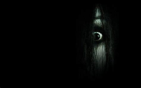 an evil looking woman in the dark with her eyes wide open and long ...