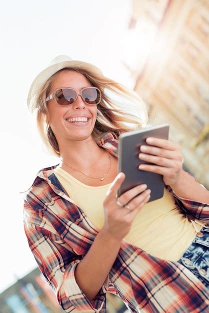 Mujer Joven Feliz Que Usa Una Tableta Foto Premium