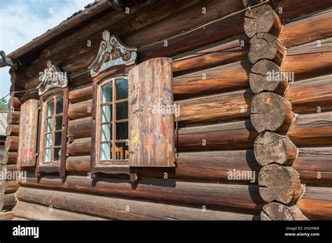 Traditional Wooden House With Folk Art Painted Shutters In The Open Air