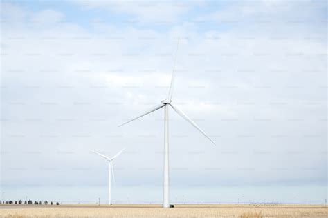 group  people standing   field   wind turbines photo