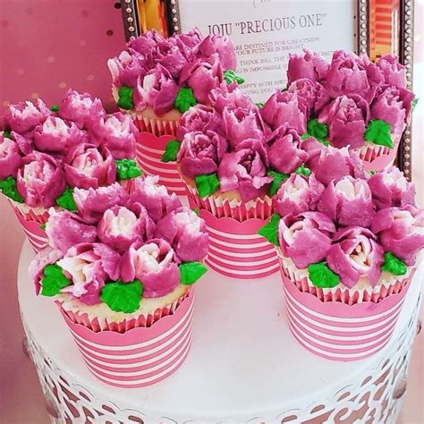 Cupcakes Decorated With Pink Flowers And Green Leaves