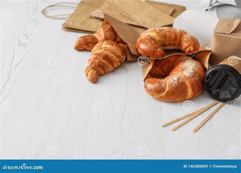 Paper Bags With Pastry And Takeaway Food On Light Table Stock Image