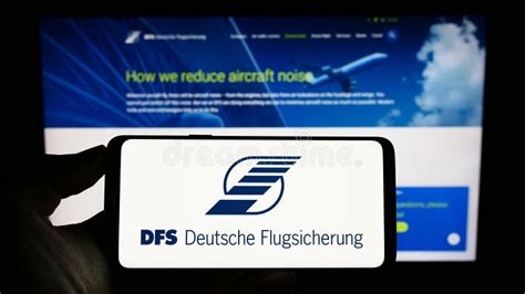 Person Holding Cellphone With Logo Of Air Traffic Control Dfs Deutsche