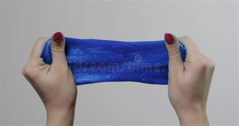 Woman Hands Playing With Oddly Satisfying Blue Slime Gooey Substance Antistress Stock Image