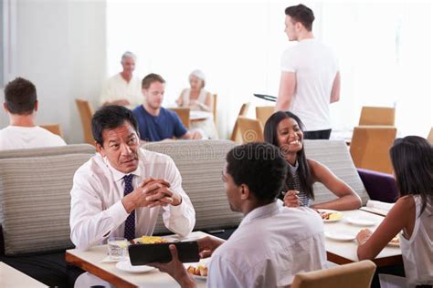 Businessmen Meeting Over Breakfast In Hotel Restaurant Stock Image