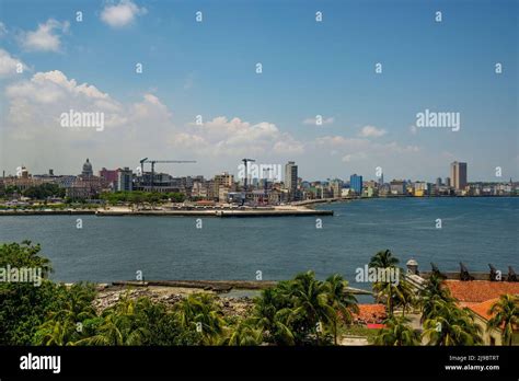 The Skyline Of Havana With A View Of Sea Waves Crashing Against The