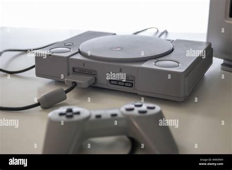 A Sony Playstation One And Controller A Games Console Released In