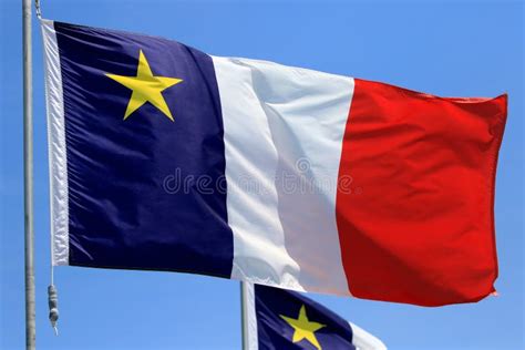 Acadian Flag With Blue Sky Background Stock Photo Image Of Canadian