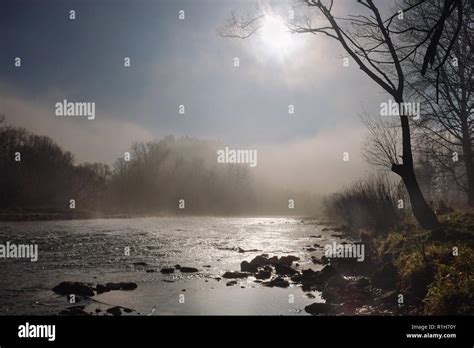 Morning Sun And Fog Hovering Over A Mountain River Stock Photo Alamy