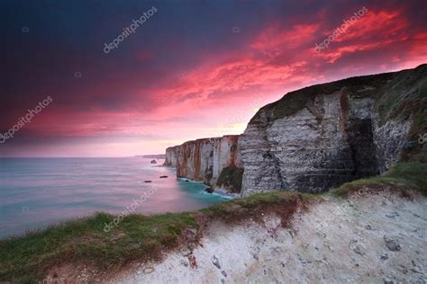 Dramatic fire sunrise over cliffs in ocean Stock Photo by ©O.Rohulya ...