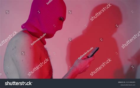 Anonymous Shirtless Man Balaclava Browsing Smartphone Stock Photo