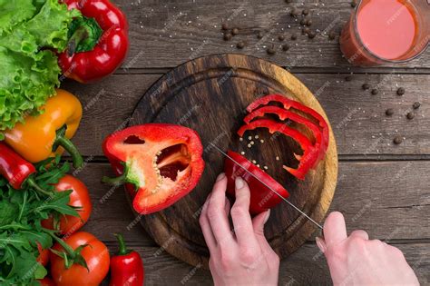 Premium Photo Female Hands Cutting Pepper At Table Top View On The