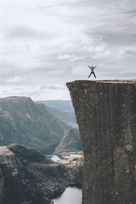 "Hiker Jumping On Preikestolen Cliff Lysefjorden - Stavanger, Norway ...