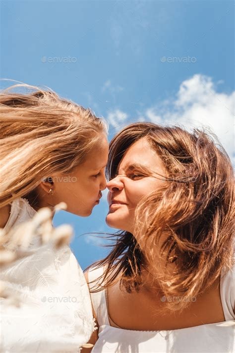 Mom and daughter fool around and make faces at each other, having fun