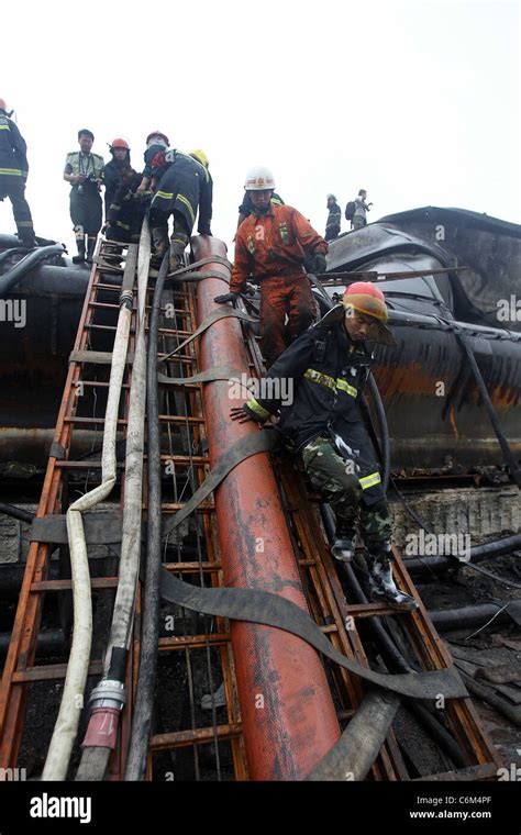 Firefighters Help Oil Blast Clean Up Firefighters In Dalian China