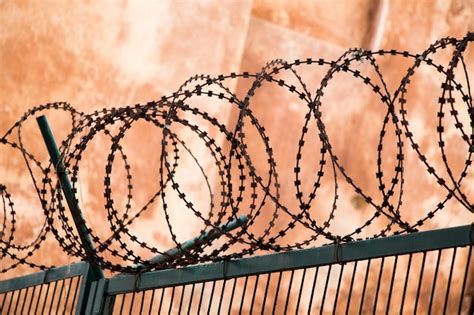 Premium Photo Barbed Wire Fence For Protection Purposes Of A Pproperty