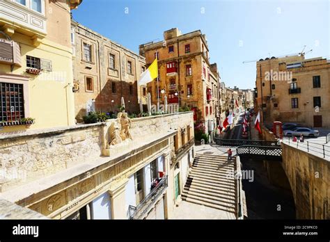 The Colorful Building With The Red Balconies Above The Victoria Gate In