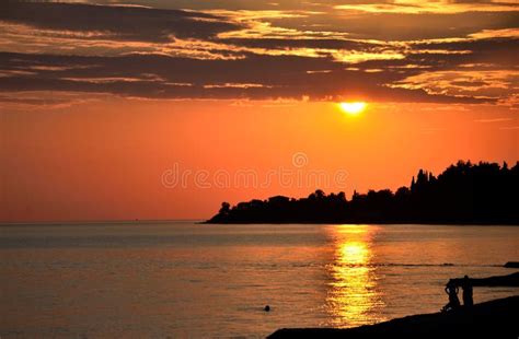 View Of The Black Sea At Sunset With People Resting Stock Photo