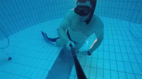 Beefy Guy Diving Deep Underwater In Speedo