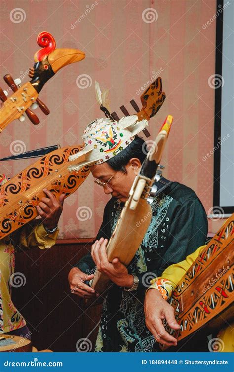 A Dayak Playing His Lute A Traditional Musical Instrument Editorial