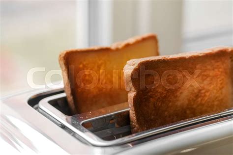 Toaster with ready bread slices in the kitchen. traditional breakfast ...